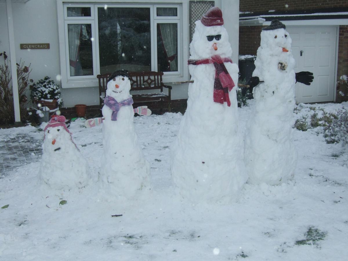 A family of snowmen - made by Pam, Phil, Elsa, Sophia and Sebastian Evelyn of Oliver's Battery, Winchester.