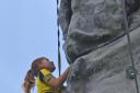Ciara Caiger-Watson, aged nine, on the climbing wall at Sherfest Outdoor Community Festival. Picture by Emma Sheppard