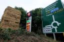 Why did farmer block Hampshire service station sign with hay bales?