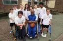 Wheelchair basketball star Sinclair Thomas with pupils from Kings' School