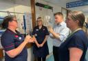 Trust chief executive Alex Whitfield (right), Steve Brine MP and staff at Florence Portal House maternity unit