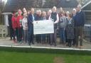 Town bowling club presents £2,500 to charity Simon Says