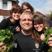 19 May 2013 - Alresford Watercress festival 2013 - Glenn Walsh celebrates after breaking the world record for eating 2 bags of watercress after eating them in 35 seconds , Glenn celebreats with his 13 year old triplet daughters (l-r) Beth , Laura and