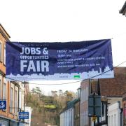 A banner for the jobs and opportunities fair flying in Winchester High Street
