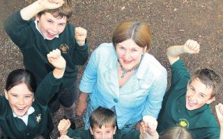WELL DONE: Head teacher Lesley Pennington and some of her pupils