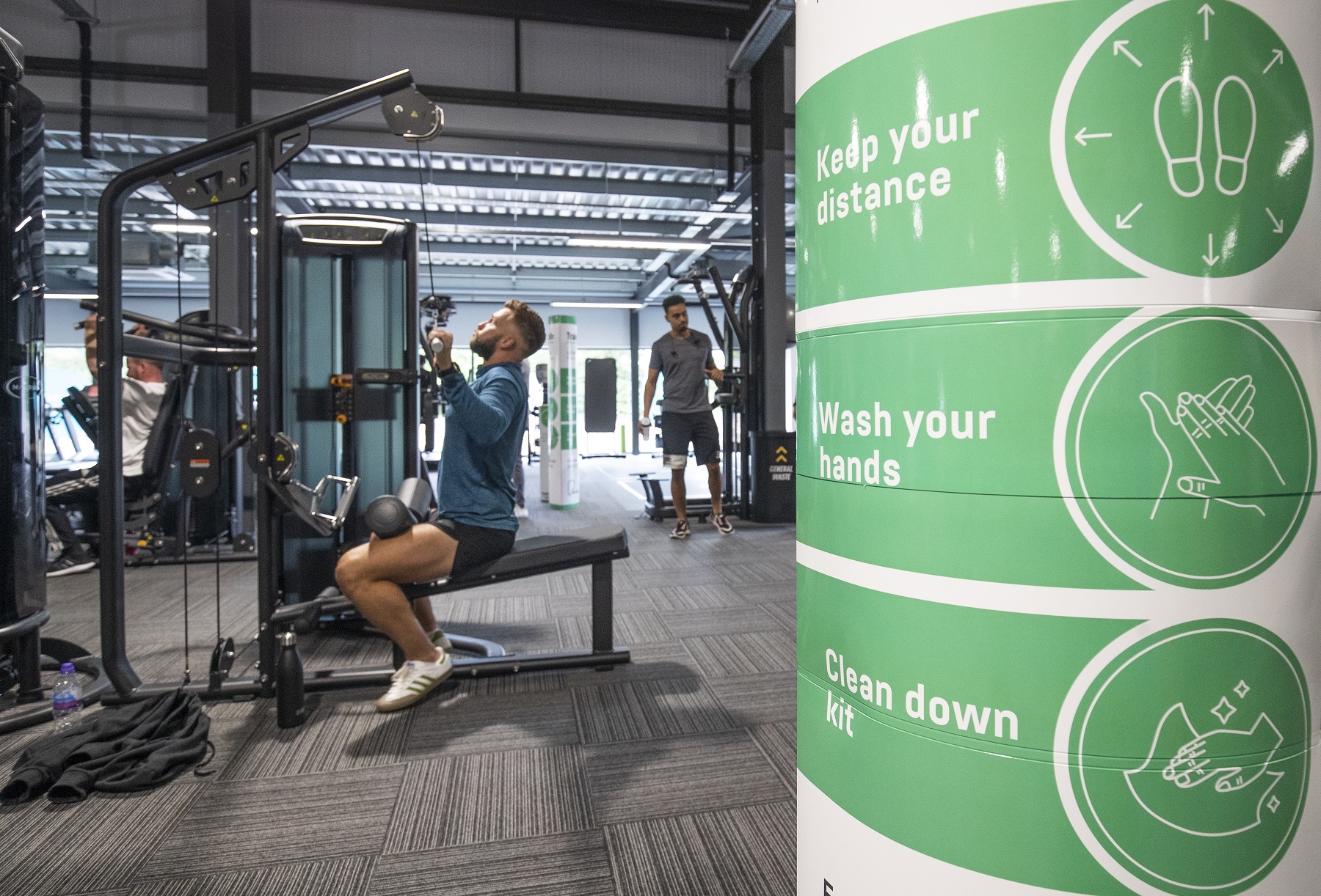 Gym members work out on socially-distanced fitness machines at the new PureGym Local in Kirkcaldy, Fife..