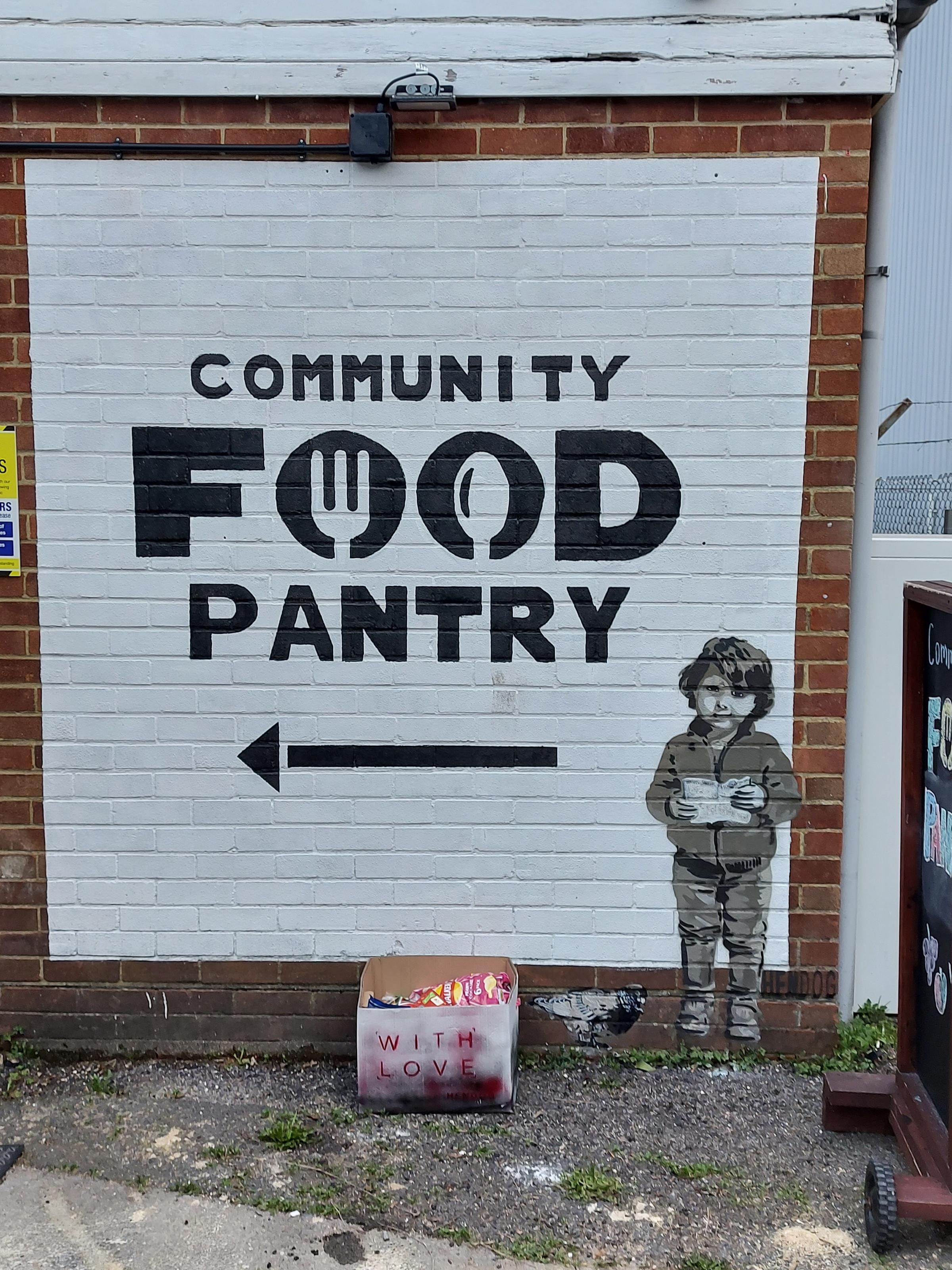 The Banksy-style artwork at the Community Food Pantry