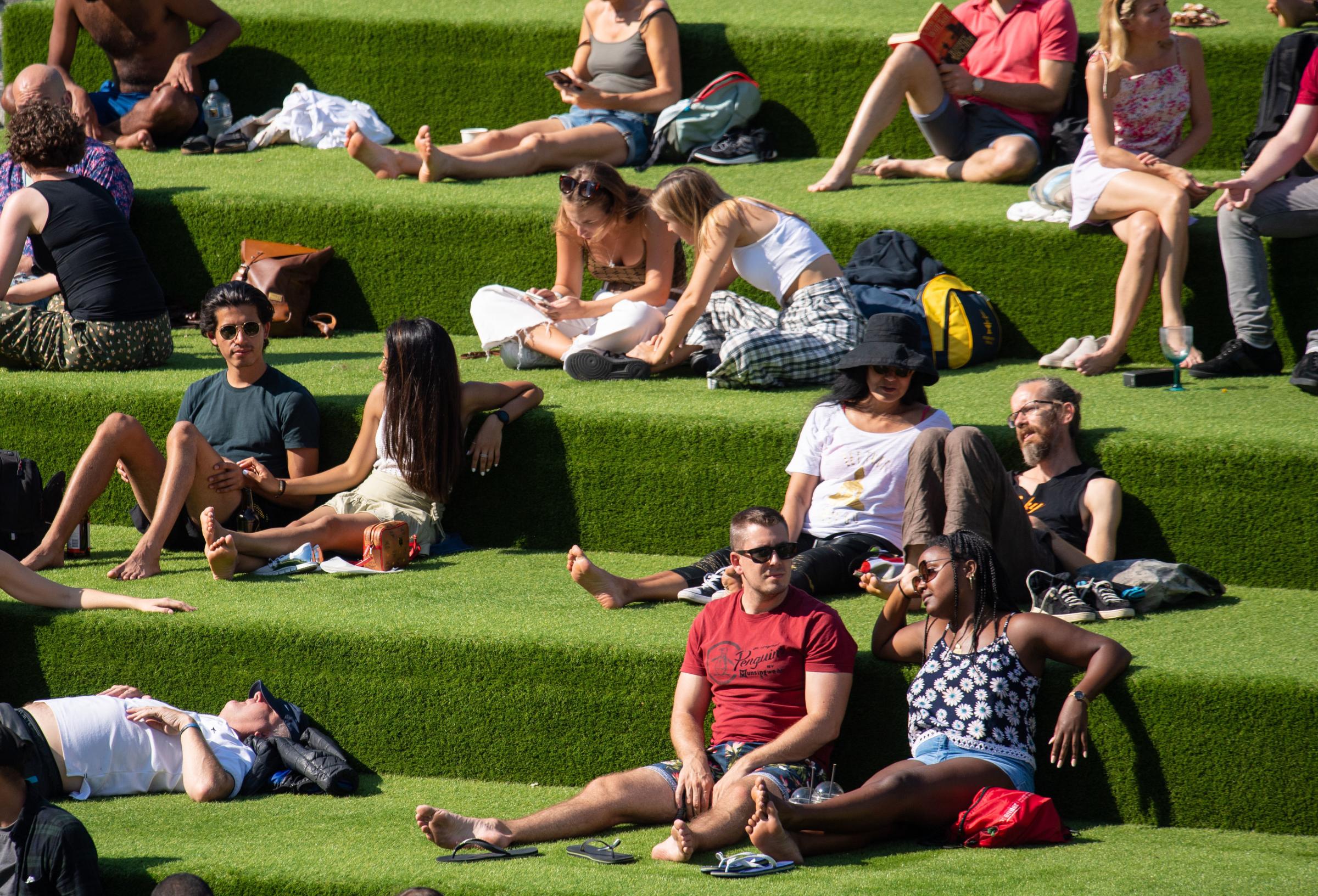 People enjoying the Autumn sunshine in Kings Cross, London. The public has been urged to act in tune with Covid-19 guidelines before the rule of six restrictions come into force on Monday. PA Photo. Picture date: Sunday September 13, 2020. Photo