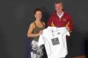 Andy Worth, first team captain at Sparsholt Cricket Club, hands over the shirts to Joanna Hancock, events coordinator at Rwanda Cricket Stadium Foundation.