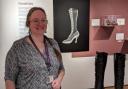 Ruth James, social history conservator, alongside some Victorian boots