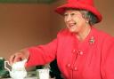 The Queen joined Mrs Susan McCarron for tea in her home in the Castlemilk area of Glasgow in 1999. Picture: PA