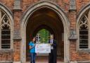 Winchester College student Thomas Sharrock presents Winchester's Naomi House & Jacksplace with cheque