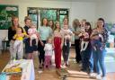 Eco Montessori nursery kids, mums and staff with children's cookery author Annabel Karmel (centre)
