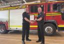 James Everett  being presented with a Chief Officer’s Commendation certificate by Neil Odin for his heroic actions