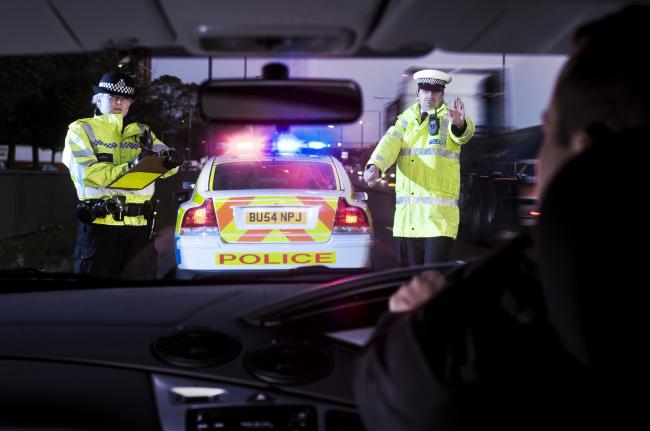 Stock image of a person being pulled over by police