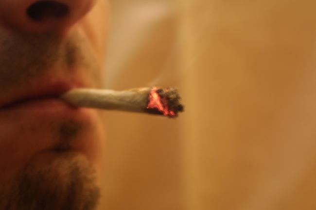 Man smoking a cannabis joint. Stock image