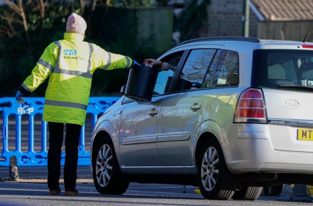 Hampshire Chronicle: A member of NHS Test and Trace collects a sample from a member of the public at the drive-thru Covid-19 testing site (PA)