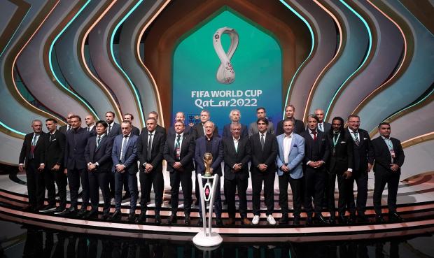 Hampshire Chronicle: Managers, including England manager Gareth Southgate (back row third left), on stage during the FIFA World Cup Qatar 2022 Draw. Picture: PA