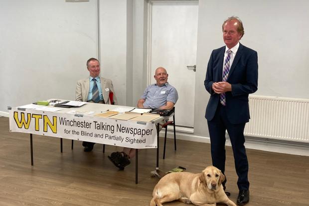 From left: Keith Vincent and Peter Liddiard, WTN trustees. Standing is Tom McInulty, accompanied by guide dog Toby
