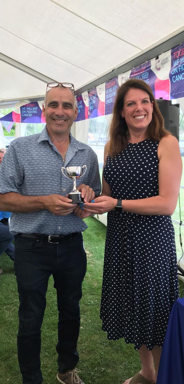 Hampshire Chronicle: Trevor Bell receiving the trophy from MP Caroline Nokes