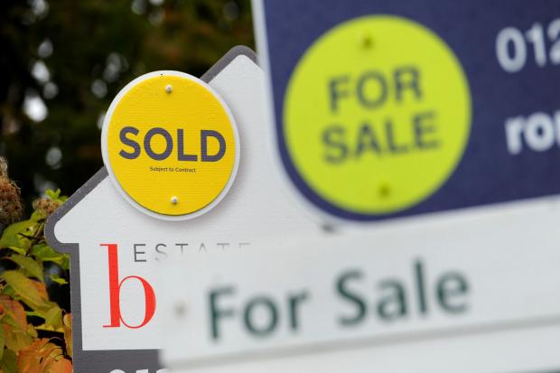 File photo dated 14/10/14 of a sold and for sale signs. A gradual slowdown in the housing market in Scotland is likely as the cost-of-living crisis bites, a report has warned. House prices in Scotland continue to edge upwards but indicators are softening