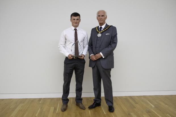 Hampshire Chronicle: Chairman, Councillor Mel Kendal, presents Sam Winterburn with the Apprentice of the Year award