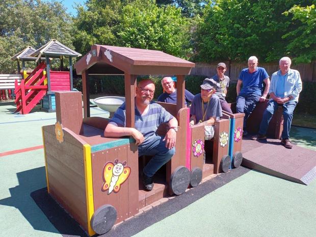 Hampshire Chronicle: Romsey's Men's Shed group surrounding a train made by them for Romsey Oppurtunity Group.