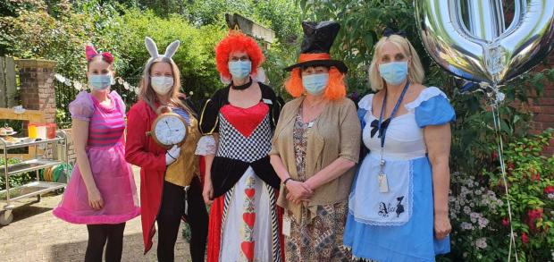 Hampshire Chronicle: from left: Customer Advisor and Cheshire Cat Vanessa Hall; Companionship Team Leader and White Rabbit Laura Sheldrake; Home Manager and Queen of Hearts Vanda Baker; Senior Administrator and Mad Hatter Ilsa Niemela; and Clinical Lead, and Alice herself,