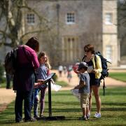 A family undertaking an Easter Egg Trail at Hinton Ampner