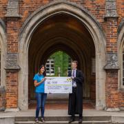 Winchester College student Thomas Sharrock presents Winchester's Naomi House & Jacksplace with cheque