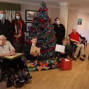 Children and teachers from Otterbourne Church of England Primary School exchange gifts with the residents and staff at Brendoncare Otterbourne Hill nursing home