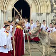 Dermot the donkey outside the Great Hall with the Dean of Winchester Catherine Ogle