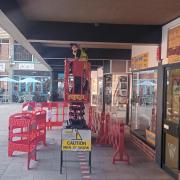 Workmen upgrading lighting at Kings Walk in Winchester