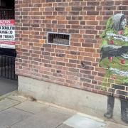 Hendog mural of Big Issue seller Kev Collick at doomed Friarsgate Surgery