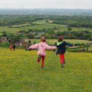 Children jumping for joy in the South Downs National Park