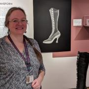 Ruth James, social history conservator, alongside some Victorian boots