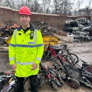 Inspector Andy Tester  and the crushed bikes and scooters