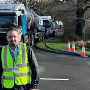 Cllr Geoff Cooper in front of the tankers