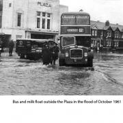 Bus and milk float outside the Plaza in the flood of October 1961