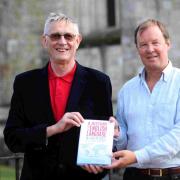 Prof Christopher Mulvey (left) with Bill Lucas and a copy of A History of the English Language in 100 Places. Photo taken in 2013.