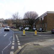 Friarsgate Medical Centre with the site of the proposed dig where the cars are parked