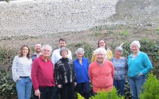 Directors of the Marston Gate Management Company and other residents in front of a rebuilt section of the wall