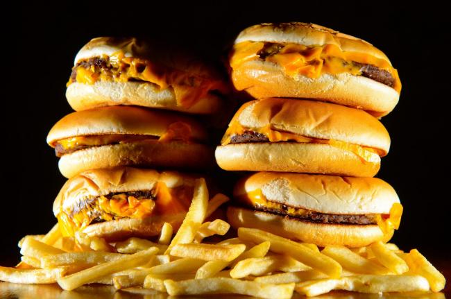 Embargoed to 0001 Thursday December 8..File photo dated 09/07/14 of a pile of cheeseburgers and french fries, as junk food advertising is to be banned across all children's media - including online and social - in a landmark decision to help tackle ch