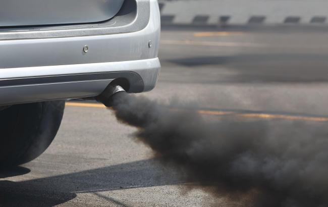 Air pollution from vehicle exhaust pipe on road..